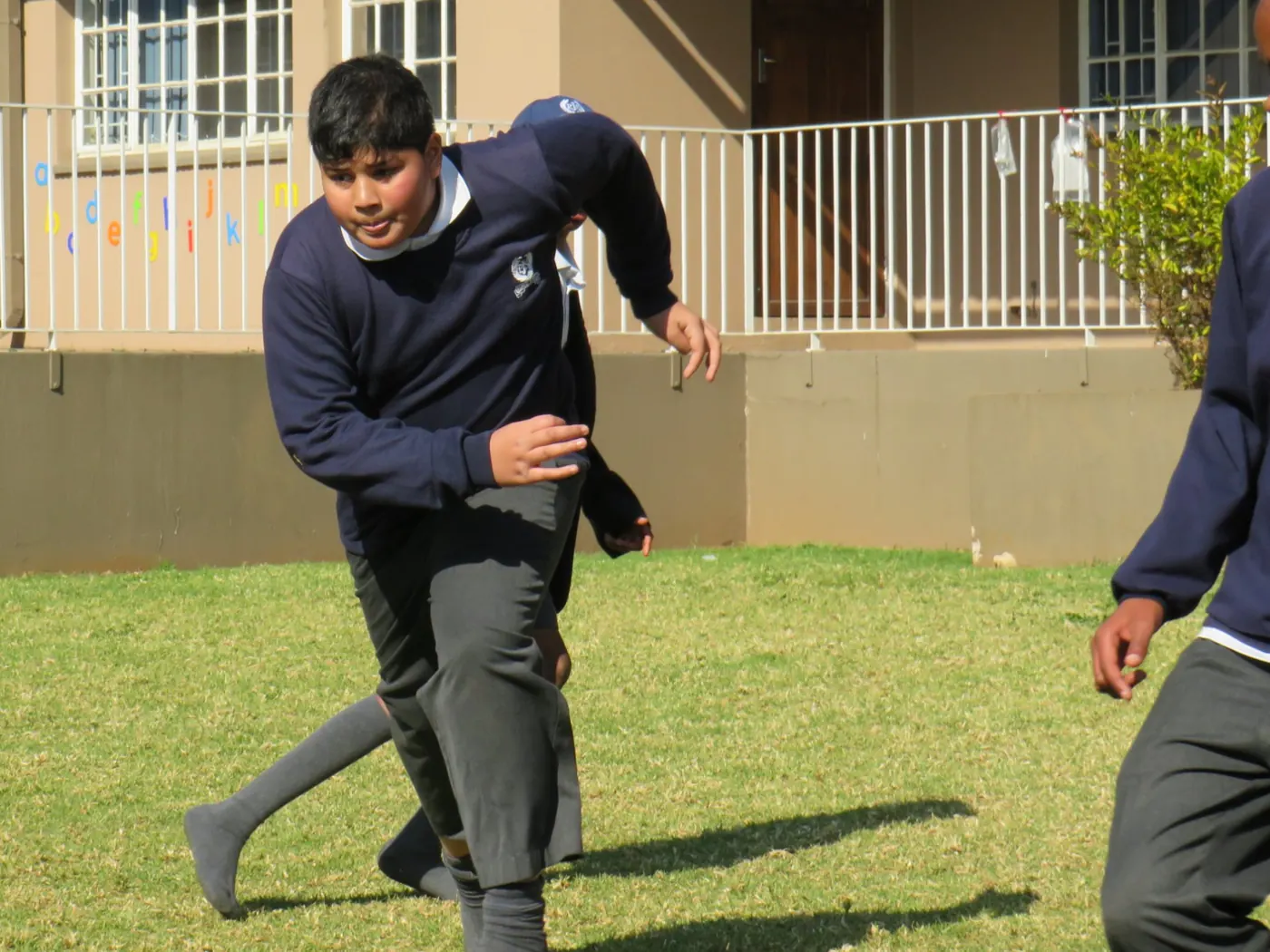 A pupil running on the lawn